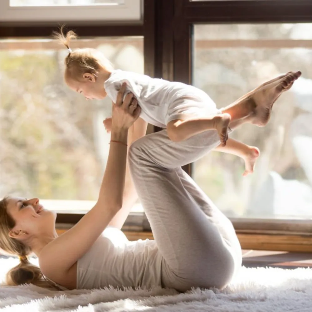 Woman stretching in a sunlit space